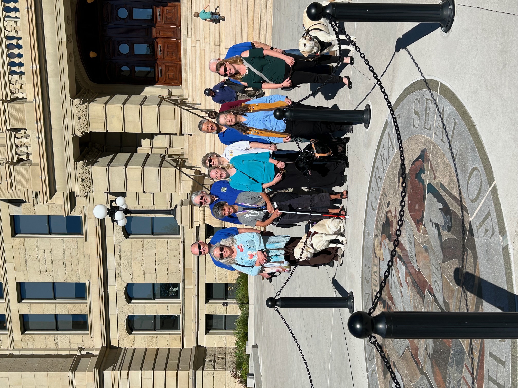 Group standing in front of the State Seal of Wyoming