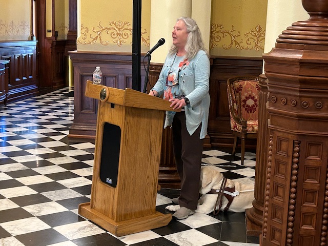 Cheryl Godley speaking at podium at White Cane Proclamation Day