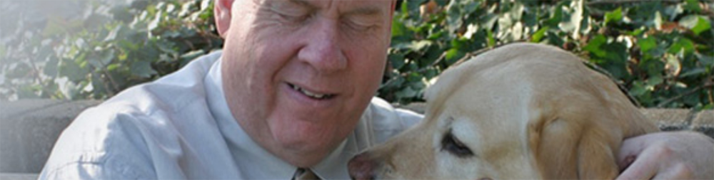 Close up of Michael Hingson and guide dog